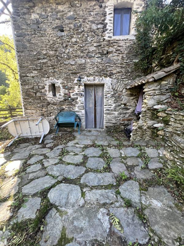 Façade en pierre de Moulin 3 et sa terrasse dallée de pierre